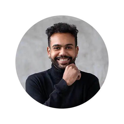 Smiling man in black turtleneck.