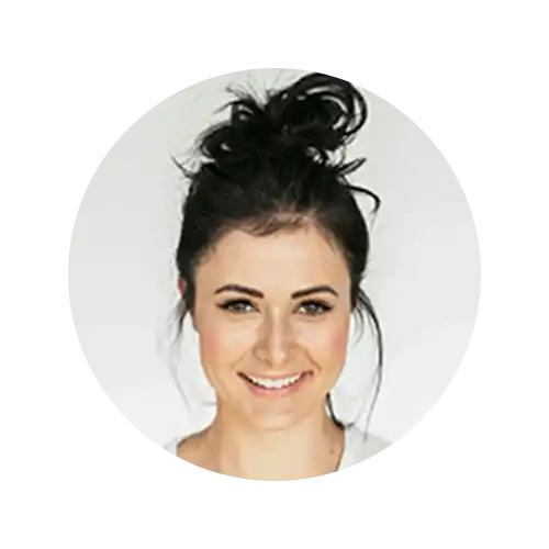 Smiling woman with messy bun.