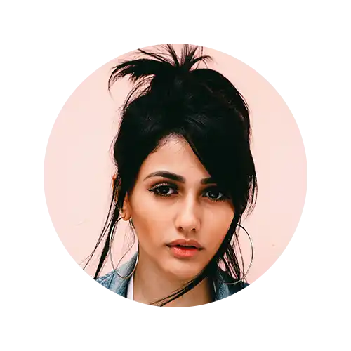 Woman with dark hair and hoop earrings.